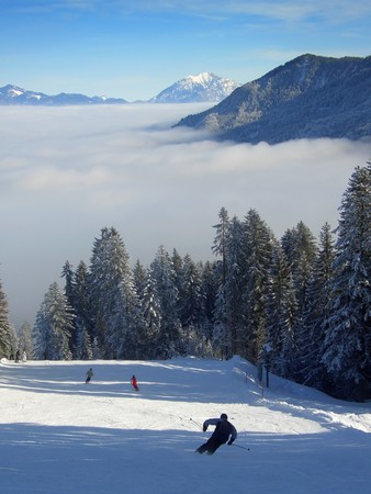 Ski track descending towards the cloudsの写真素材