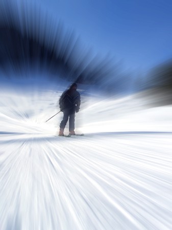 Downhill skier in black outfit radial blurの写真素材