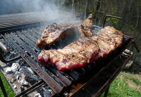 Large ribs being grilled on the barbecue, not done yetの写真素材