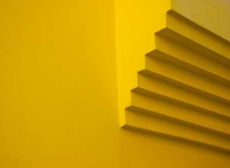 Detail of a segmented chimney's end on a yellow wall in Caorle, Veneto, Italyの写真素材