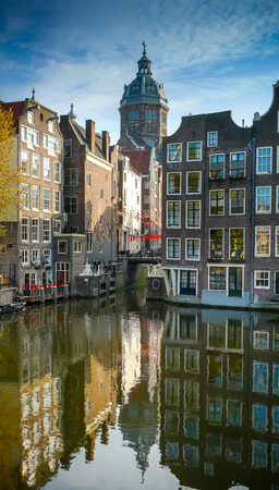 Amsterdam old town buildings and St Nicholas church dome reflecting on Oudezijds Voorburgwalの写真素材