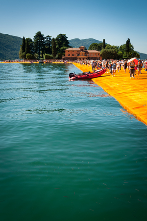 SENSOLE, ITALY - JUNE 27: Christo's Floating Piers installation near Isola  di San Paolo on June 27th, 2016. The bulgarian artist's project connects Montisola and San Paolo island to the mainland.のeditorial素材