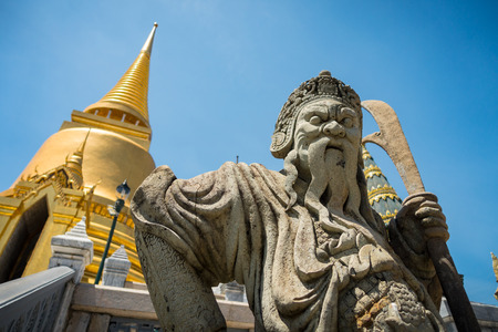 A granite mythical thai warrior guarding the temples inside the Grand Palace complex in Bangkok, Thailandの写真素材