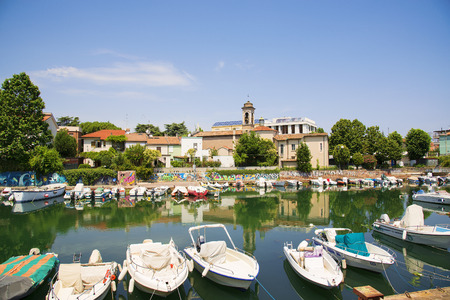 Scenic spring view of pier with ancient and modern buildings, ships, yachts and other boats in Rimini, Italyのeditorial素材