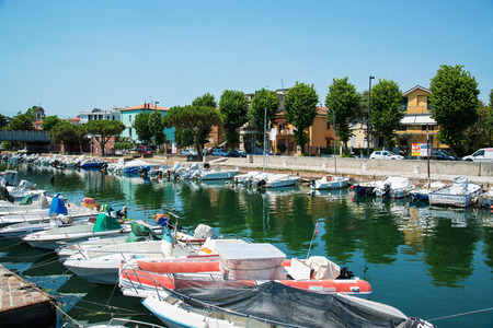 Picturesque summer view of the pier with ancient and modern buildings, yachts and other boats in Rimini, Italy - June 21, 2017のeditorial素材