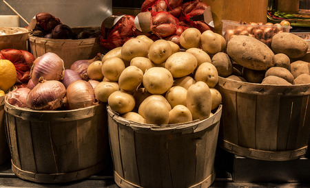 Harvest of potatoes and onions in a basketの写真素材