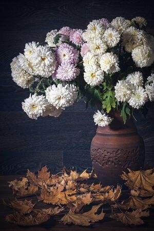 Autumn bouquet with garden flowers and autumn leavesの写真素材