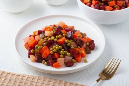 Traditional Russian lean vegetable salad vinaigrette in a white plate.の写真素材