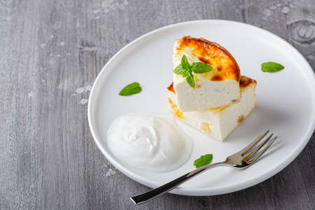 Cottage cheese casserole with raisins and semolina on wooden gray background. Cottage cheese casseroleの写真素材