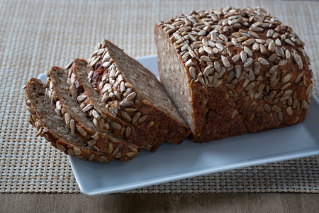Sliced rye bread on the plate. Whole grain rye bread with seeds