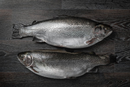 Fresh raw salmon red fish on a wooden table. Creative layout made of fish, seafood, top view, flat...
