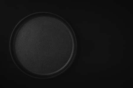 Empty metal tray on a black background. Space for textの写真素材