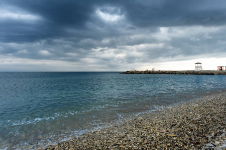 Scenic landscape of the beach and dark blue sea, cloudy sky before a thunderstorm. A bay in the resort village of Nebug, Krasnodar Territory.の写真素材
