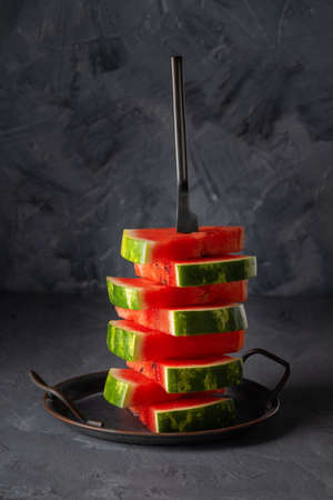 Fresh slices of watermelon on table against grey background. Copy spaceの写真素材