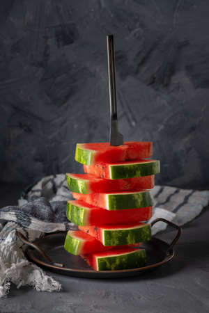 Fresh slices of watermelon on table against grey background. Copy spaceの写真素材