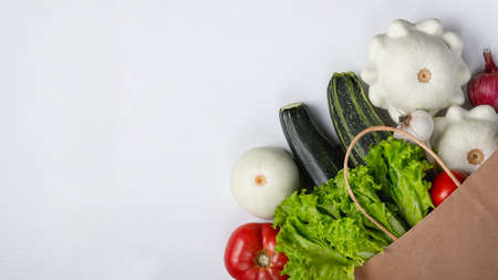 Paper bag with vegetables on white backgroundの写真素材