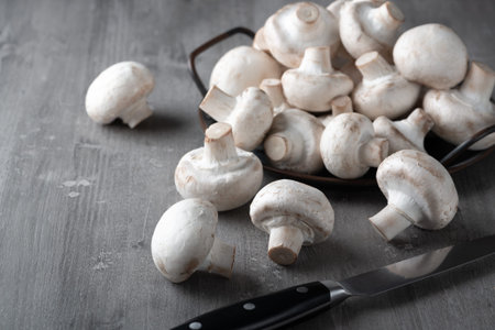 Raw fresh mushrooms on a wooden tableの写真素材