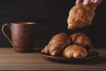 Beautiful morning breakfast gathering with fresh croissantsの写真素材