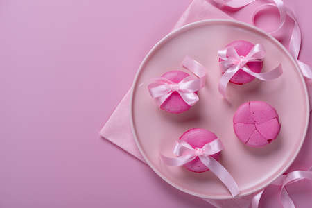Pink macaroons on pink background. Sweet background.の写真素材