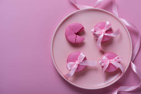 Pink macaroons on pink background. Sweet background.の写真素材