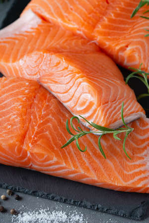Raw salmon fillet and ingredients for cooking, seasonings and herbsの写真素材