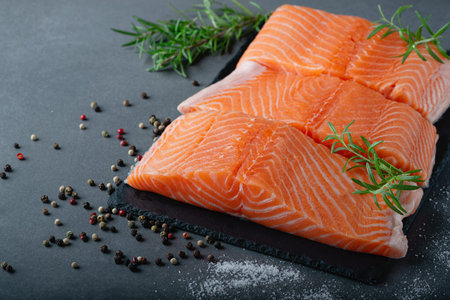 Raw salmon fillet and ingredients for cooking, seasonings and herbs