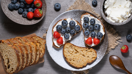 Fresh breakfast with blueberry, strawberry and ricotta rye sandwichesの写真素材