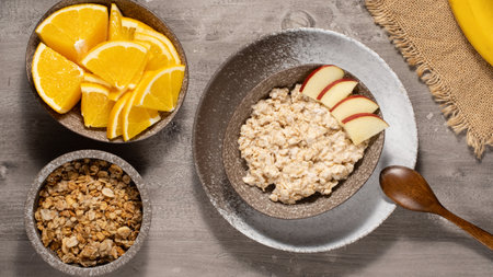 Oatmeal porridge with fruits for healthy breakfast. Table top viewの写真素材