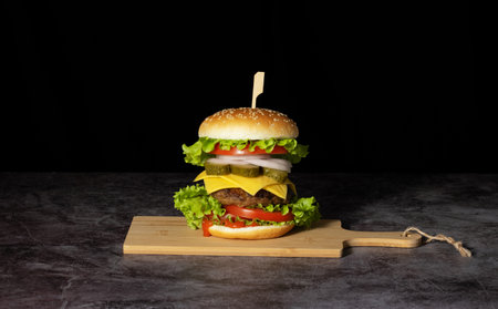 Fresh tasty burger on dark background. Copy space for text.の写真素材