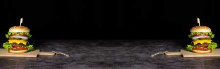 Fresh tasty burger on dark background. Copy space for text.の写真素材