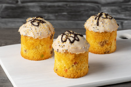 Easter cupcakes on gray wooden background.