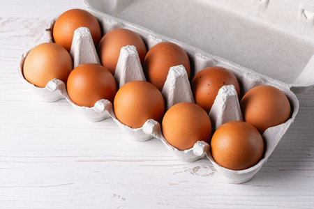 Farm raw fresh egg in pack on white wooden table