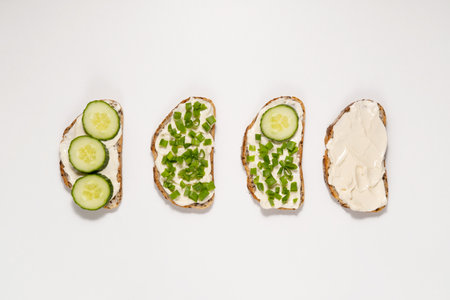 Sandwiches with cream cheese, cucumbers and green onions. Healthy eating conceptの写真素材