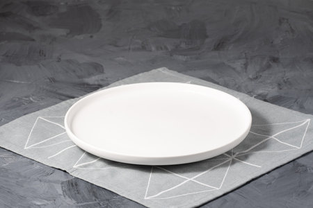 Empty white plate over gray concrete backgroundの写真素材