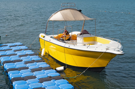 A yellow yacht at the pier at anchorの写真素材