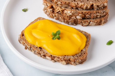 Sandwich with tasty pumpkin jam on tableの写真素材