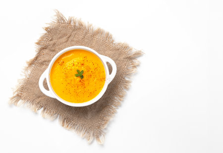 Pumpkin soup with croutons on white background, with copy space for textの写真素材