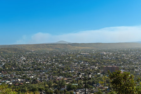 Panoramic top view of Pyatigorsk, Stavropol territory with residential buildings among green trees and cloudy sky above the horizonの写真素材