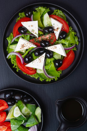 Greek salad with fresh vegetables and feta cheese.の写真素材