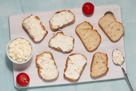Sandwiches with cream cheese on a green table