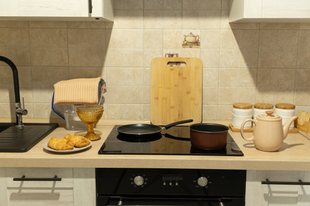 Modern Kitchen Setup with Teapot and Bunsの写真素材