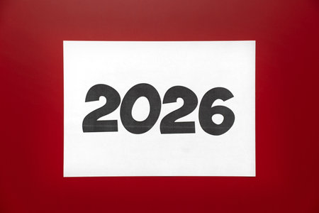 A large white print displaying the number 2026 stands out against a vibrant red background, symbolizing upcoming year and future aspirations, focusing attention on new beginningsの写真素材