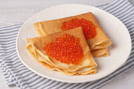 Freshly baked pancakes with red caviarの写真素材