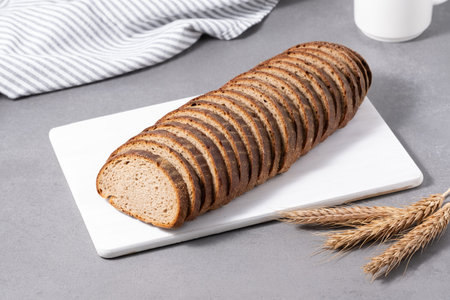 Sliced rye bread on cutting board. Whole grain rye bread
