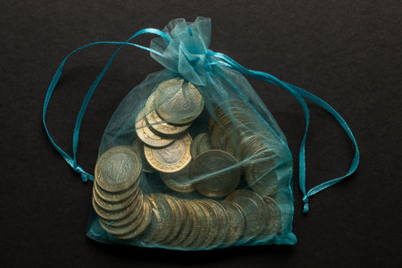 1 turkish lira coins in pouch on black backgroundの写真素材