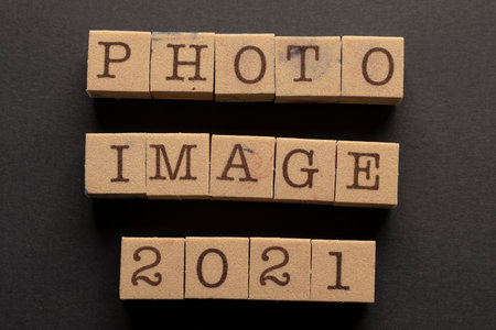 Close-up typewriter stamp on black background, letter words and reverse and straight numbers letters written in red navy blue inkの写真素材