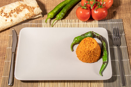whole on a plate, half grilled chicken, rice, bulgur pilaf, tomatoes, peppers and lavash bread