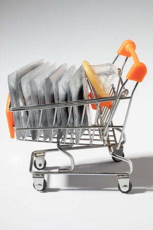 Packaged and open condoms in close-up concept supermarket trolleyの写真素材