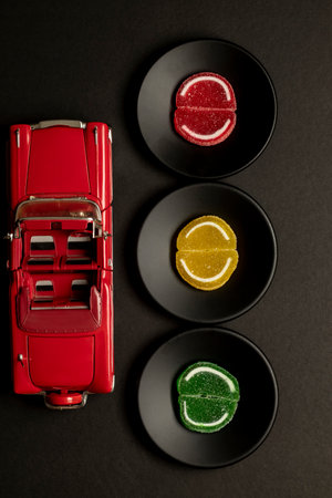 traffic light concept design of colored soft candy on black background in close-upの写真素材