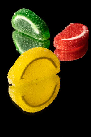 close-up black background mixed color fruit flavored sweet soft candyの写真素材